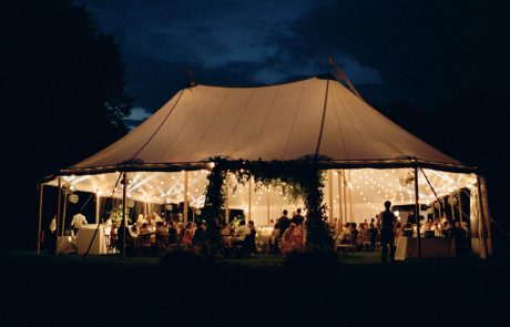 a glowing tidewater sailcloth wedding reception tent at night