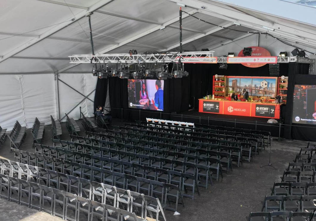 on-location television shoot in a clear span structure